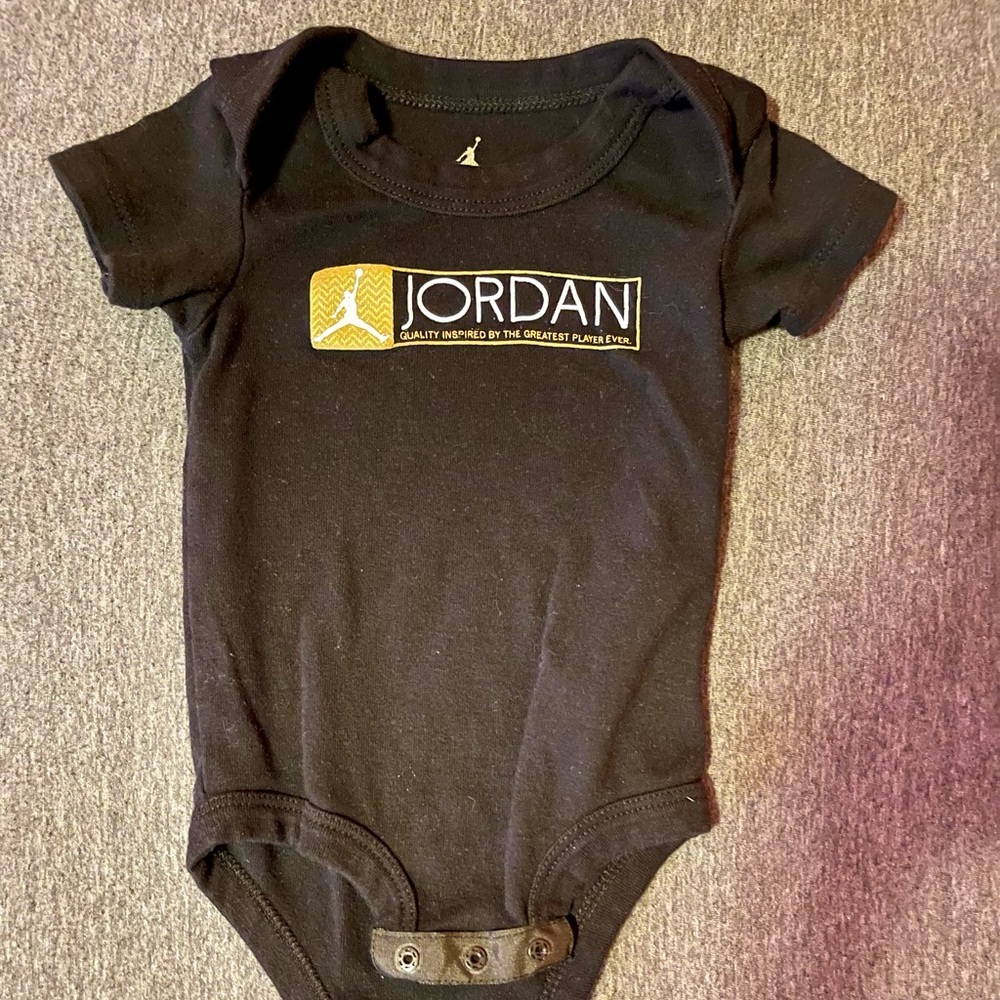 Jordan onesie ((black/gold/white)).. size 0-6 months
